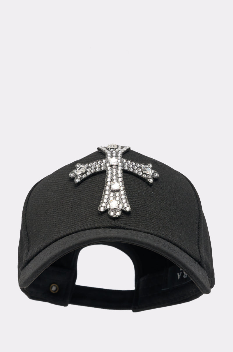 The EMBELLISH ME BASEBALL HAT is a black cap with a bold rhinestone cross on the front, shown against a light background. 2