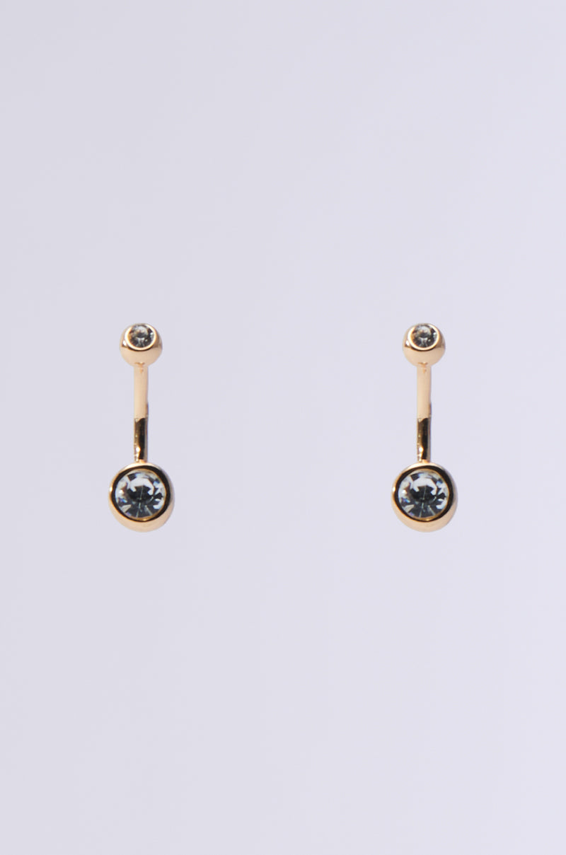 MADE YOU LOOK EARRING: A pair of gold earrings with small circular posts and larger circular dangles, each adorned with a clear rhinestone in the center, displayed on a plain light grey background.