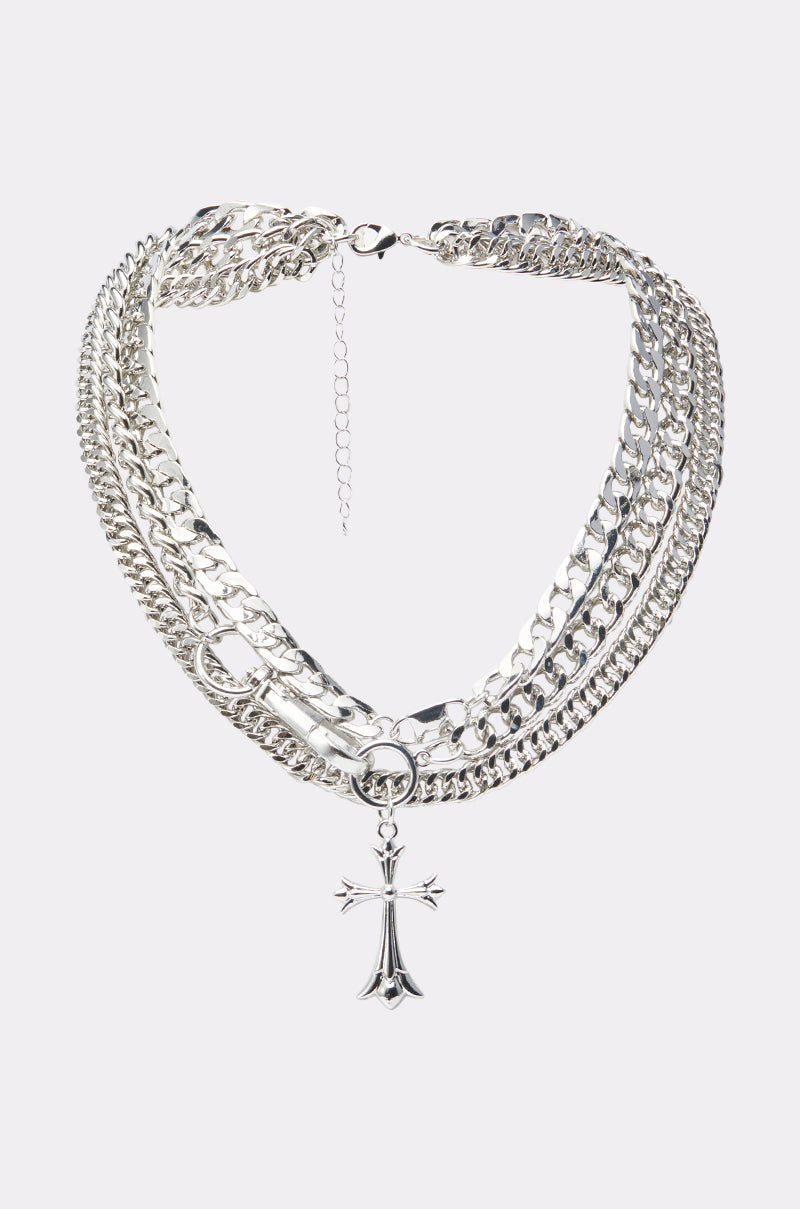 The BLESSED TO BE HOT SILVER NECKLACE features layered silver chains, a bold safety pin, and a striking cross pendant at the center. It’s finished with an adjustable clasp for a perfect fit. 0