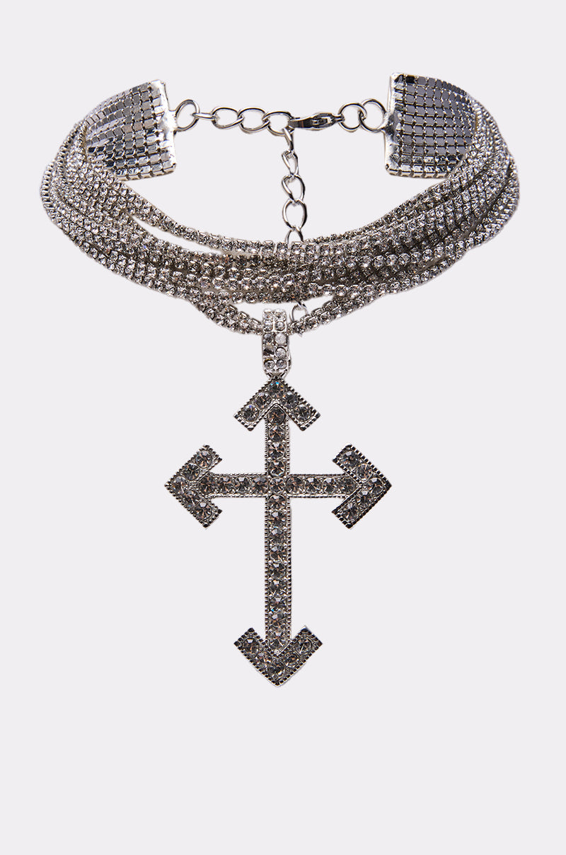The CROSS MY HEART CHOKER features multiple rows of shimmering rhinestones and a large, ornate cross charm adorned with matching stones, displayed on a plain white background. 1