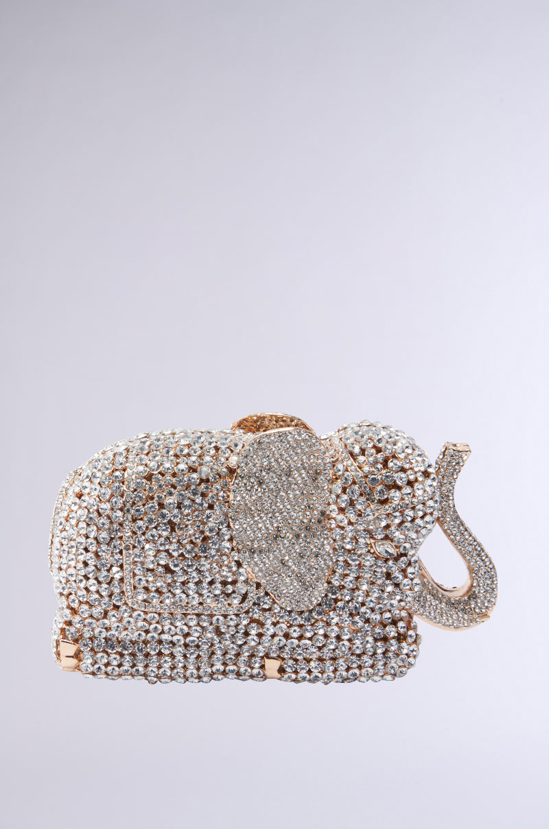 The BLING ELEPHANT CLUTCH is a luxurious purse, adorned with sparkling silver and gold rhinestones. This intricate Rhinestone Bag features detailed ears and trunk set against a soft gray background, making it an exquisite accessory for any elegant occasion.