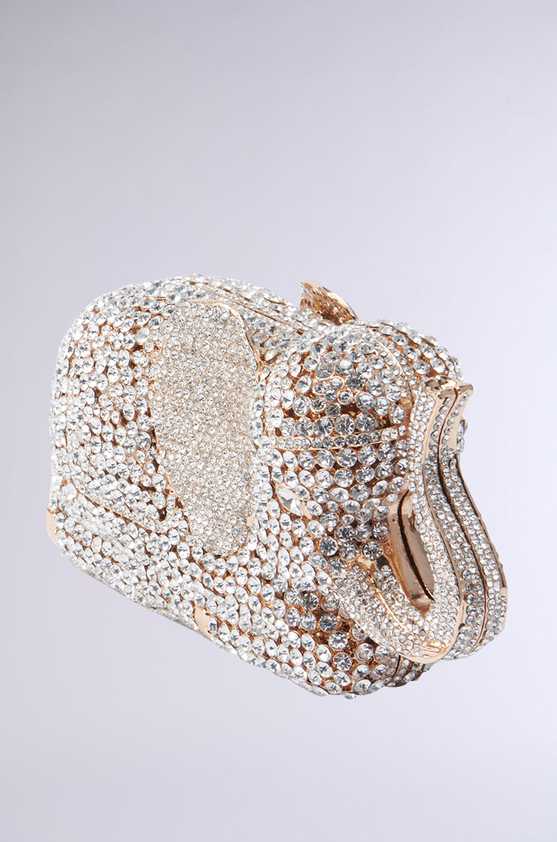 Created by the AKIRA Label, the BLING ELEPHANT CLUTCH captivates with its clusters of glittering rhinestones and gold accents against a simple background.