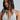 A woman with long, dark hair wears a white top with pearl strands in a crisscross design. A Pearl Goddess Hair Clip Set elegantly tames her tresses as she gazes sideways against a light background.