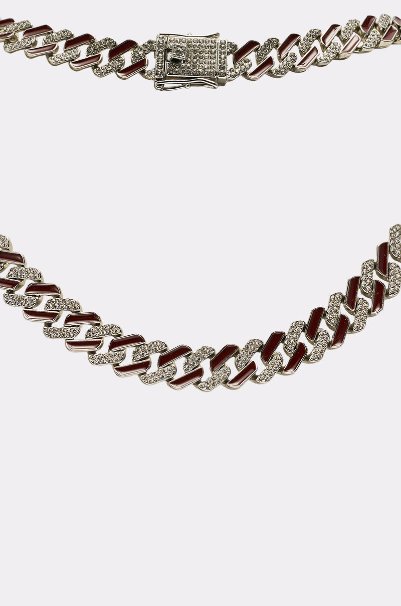 A close-up of the CANDY CANE NECKLACE, featuring alternating gold and silver rhinestone links with brown enamel accents and a jeweled clasp, displayed against a white background. 3