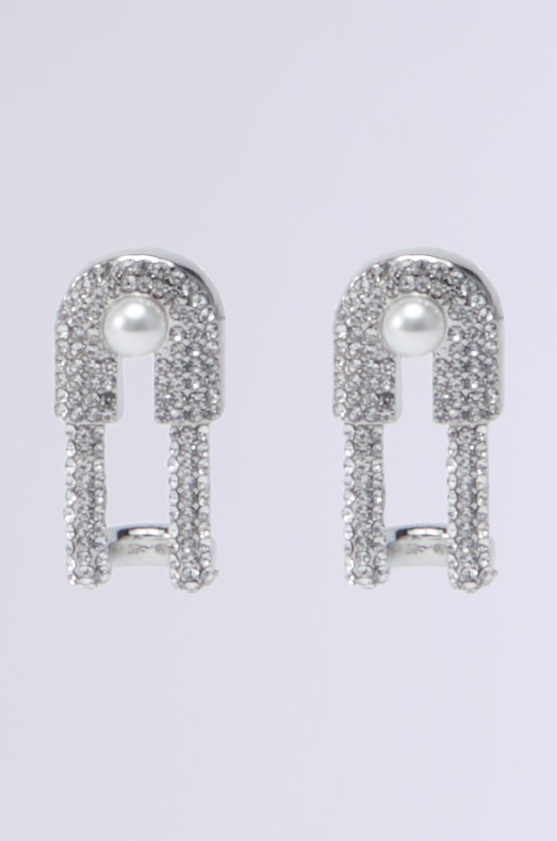 Introducing the IM TOO GOOD EARRING—a stunning pair of silver earrings featuring a paperclip-inspired design. Each piece is adorned with shimmering rhinestones and a single pearl in the upper section, creating a sophisticated and modern look.
