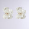 Experience elegance with the RICH BISH ENERGY EARRING, a pair of translucent flower-shaped earrings adorned with pearl centers and detailed blooming flower petal accents, set against a light gray background.