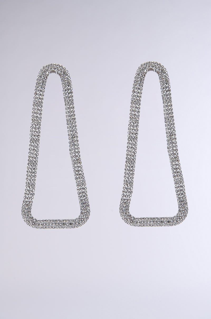 Two sophisticated Party Starter Statement Earrings, crafted in a teardrop shape and adorned with rhinestone links, are displayed against a plain white background. These silver earrings boast a contemporary geometric design ideal for making a striking entrance.