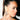 A woman with sleek, dark hair in a high ponytail wears dramatic makeup and the TO THE GALA EARRING IN SILVER from AKIRA Label, along with a rhinestone choker, looking to the side against a white background.