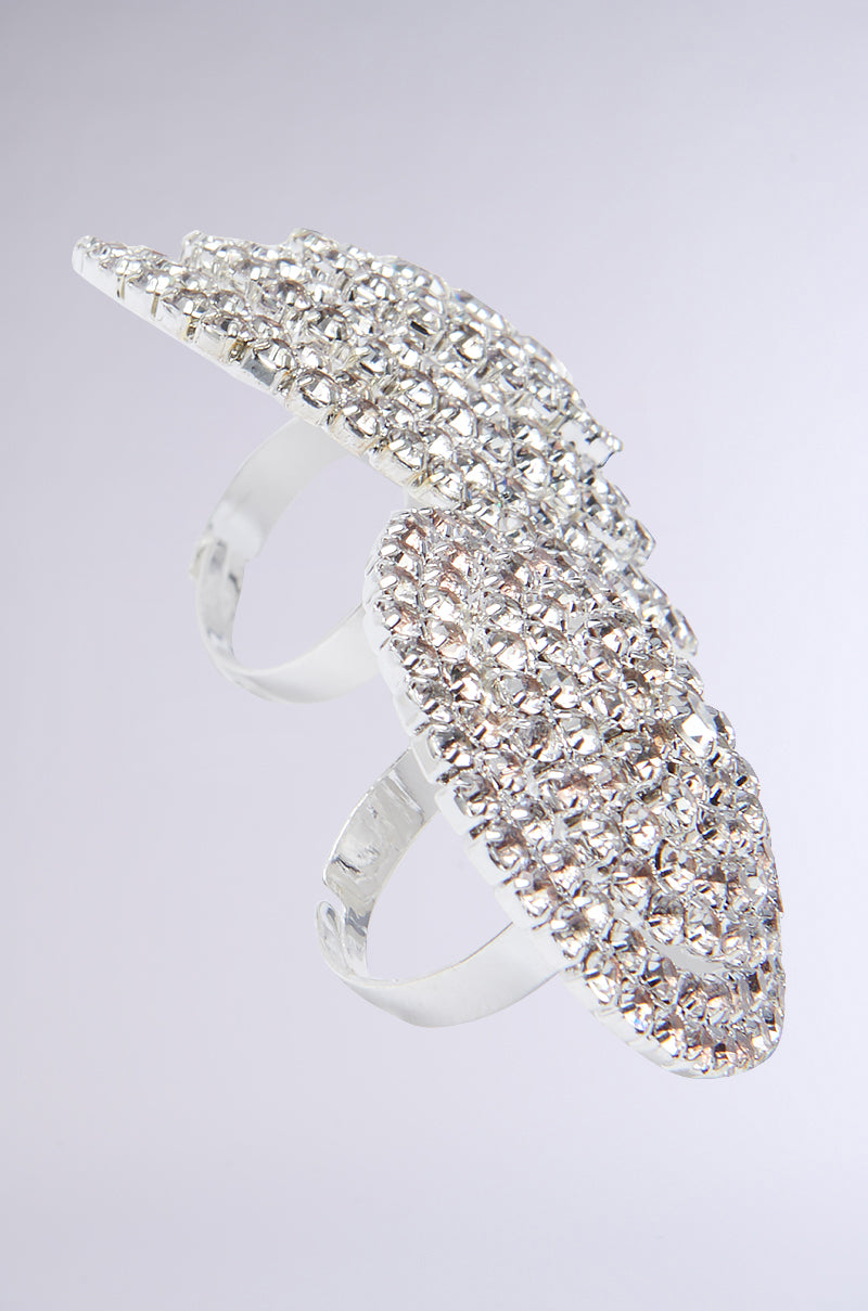 The IN PARIS BLING RING SET showcases a detailed view of faux silver metallic rings embellished with an intricate leaf motif and studded with tiny, shimmering rhinestones, all presented against a neutral backdrop.