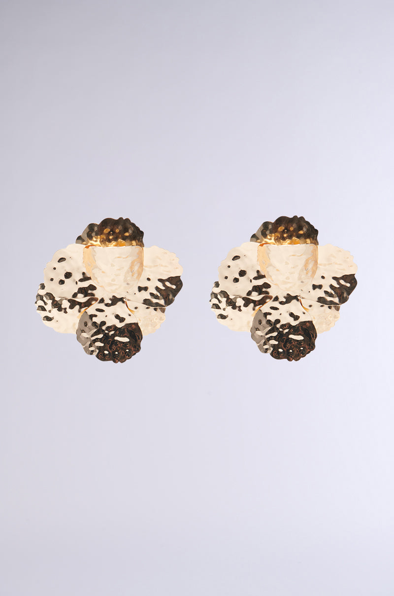 Two stunning statement earrings showcasing a floral design with textured, petal-like features in cream and dark brown hues. These oversized earrings are gracefully arranged on a light gray background, echoing the elegant tones of the Golden Hour.