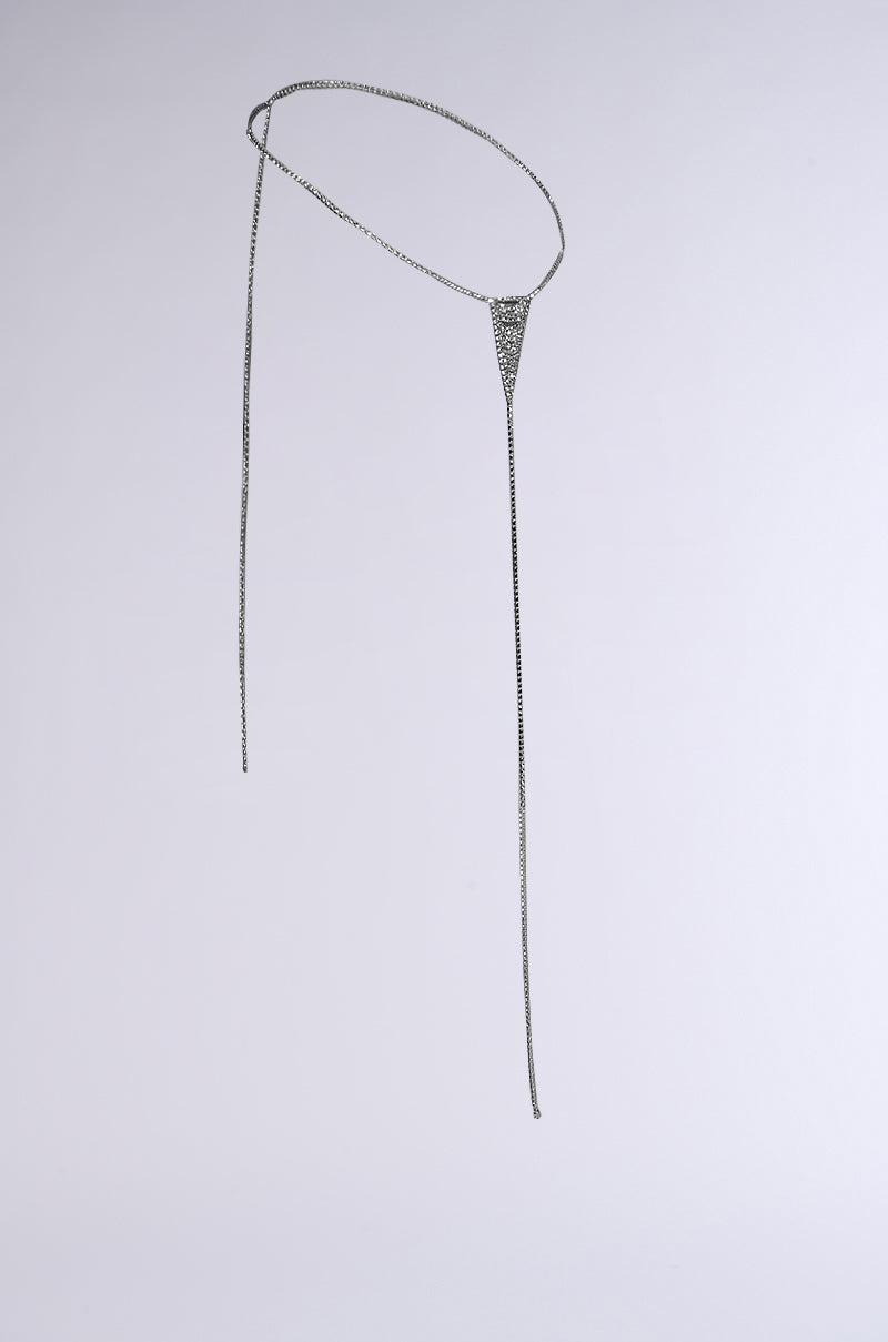 The "OOPS MY THONG CHAIN BELT" is a delicate silver accessory, featuring a triangular rhinestone centerpiece and elegant long chain ends, showcased on a plain light grey background.