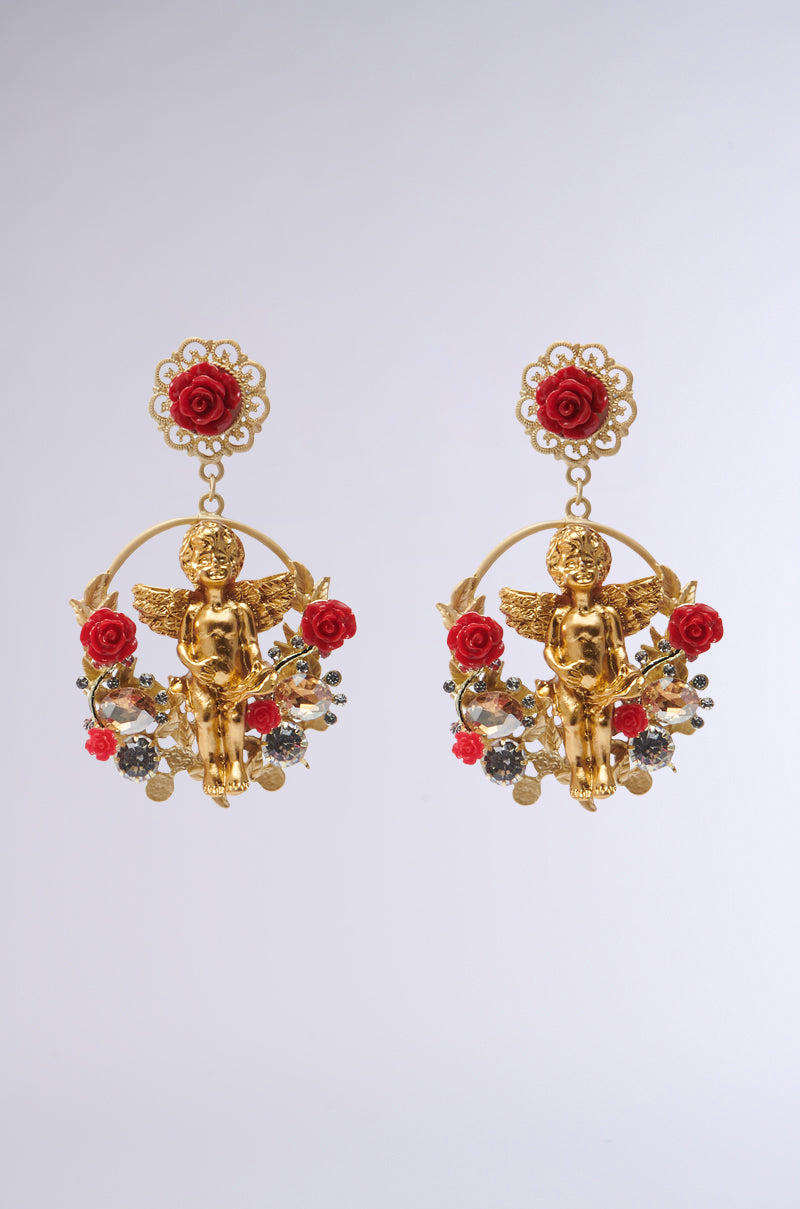 The ANGEL BABY EARRING showcases gold cherubs in circular frames, embellished with red roses, small floral motifs, and shiny bead details, perfectly blending elegance with whimsy.