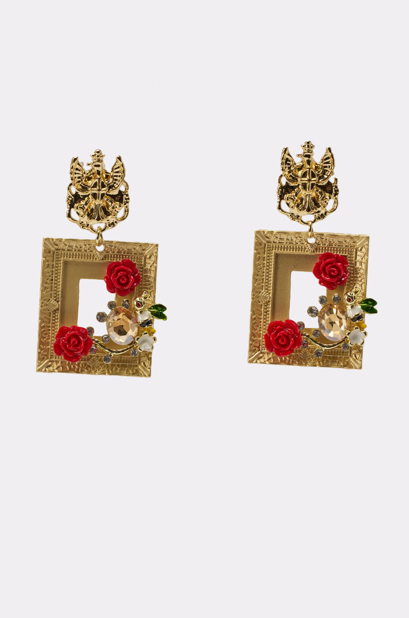 Featuring intricate designs, the PICTURE PERFECT EARRING showcases gold metallic construction with red rose embellishments, accented by gold and crystal details on a crisp white background. 0