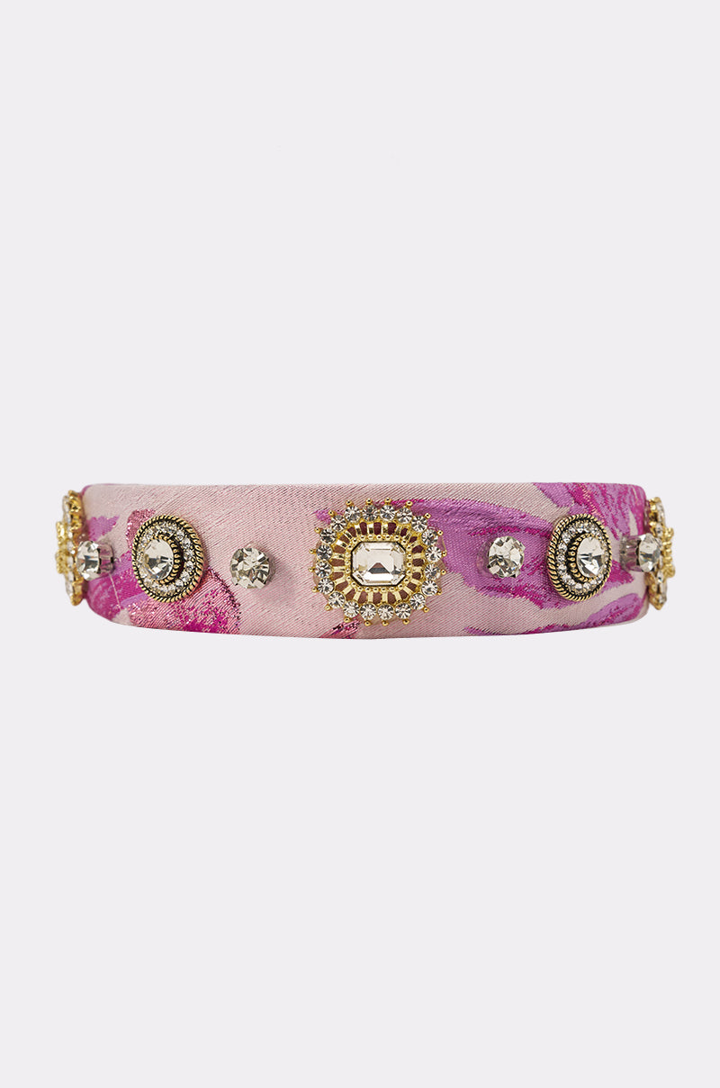 The GIRLS GIRL EMBELLISHED HEADBAND in pink and purple features gold and silver rhinestones plus gem accents in circular patterns, creating a bold, eye-catching statement accessory. 2