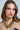 A long-haired woman softly gazes at the camera, adorned in the Pop Bubbly Necklace with gold and silver bubble beads. Her strapless black outfit beautifully contrasts with a pale background, highlighting the necklace's metallic sheen.