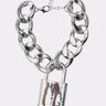 The LOVE LOCKDOWN SILVER BRACELET features a chunky silver chain with a shiny padlock charm and adjustable clasp, styled like a bold chain link, shown on a plain white background.