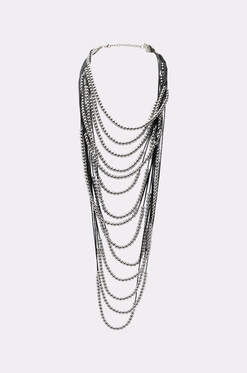 The WANNA LOVE NECKLACE showcases multiple strands of silver chains and black cords in a cascading, draped design, finished with a secure top clasp. 1