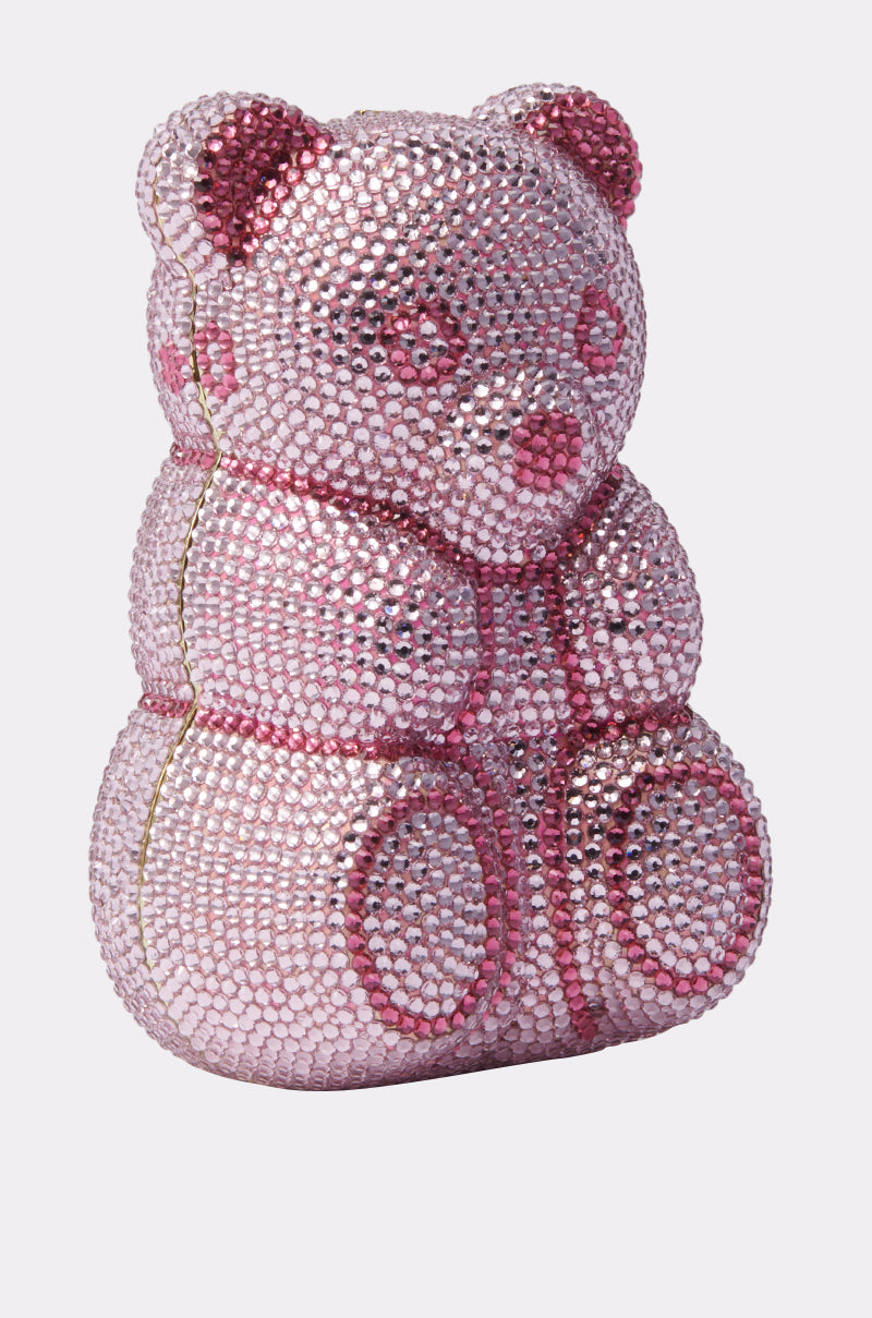 The YUMMY GUMMY BLING BAG is a teddy bear-shaped gummy bear purse adorned with sparkling pink and silver crystals, showcased on a plain light background.