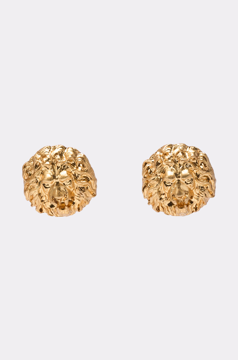 The ROAR EARRING, a pair of gold lion face studs with detailed manes and facial features, is displayed against a light gray background—perfect statement accessories. 1