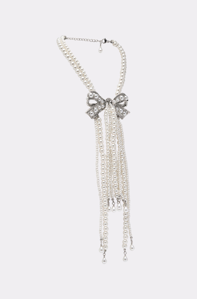 The SHANI PEARL NECKLACE features a bow-shaped silver rhinestone centerpiece with multiple pearl strands in a fringe design—a perfect, elegant choice for evening jewelry. 2