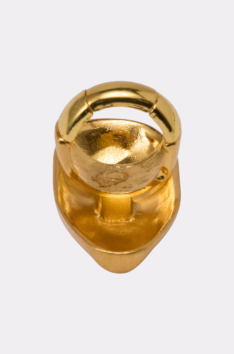 The OUTTA THIS WORLD RING, a shiny gold metallic statement piece with a smooth rounded top and textured inner surface, is shown in close-up against a light gray background. 3