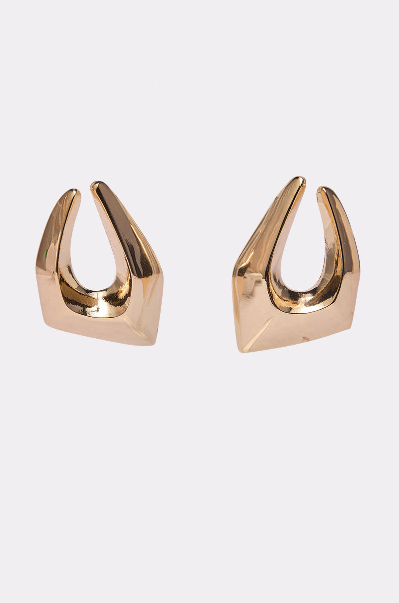 The ORIGINAL EARRING by AKIRA Label is a pair of metallic gold geometric hoops with smooth, angled edges and a shiny finish, shown against a plain white background. 0