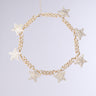 The GETTIN' STARSTRUCK NECKLACE IN GOLD showcases a chunky curb chain with rhinestone-studded star charms, beautifully displayed on a plain light gray background.