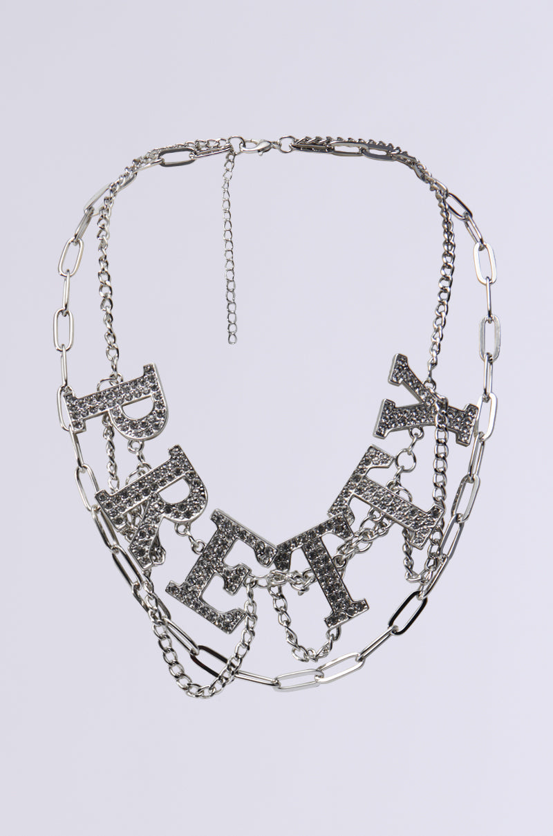 The TOO PRETTY FOR THIS NECKLACE features large, sparkling letters spelling "PRETTY" in rhinestones on a silver chain with an adjustable clasp for the perfect fit. 0