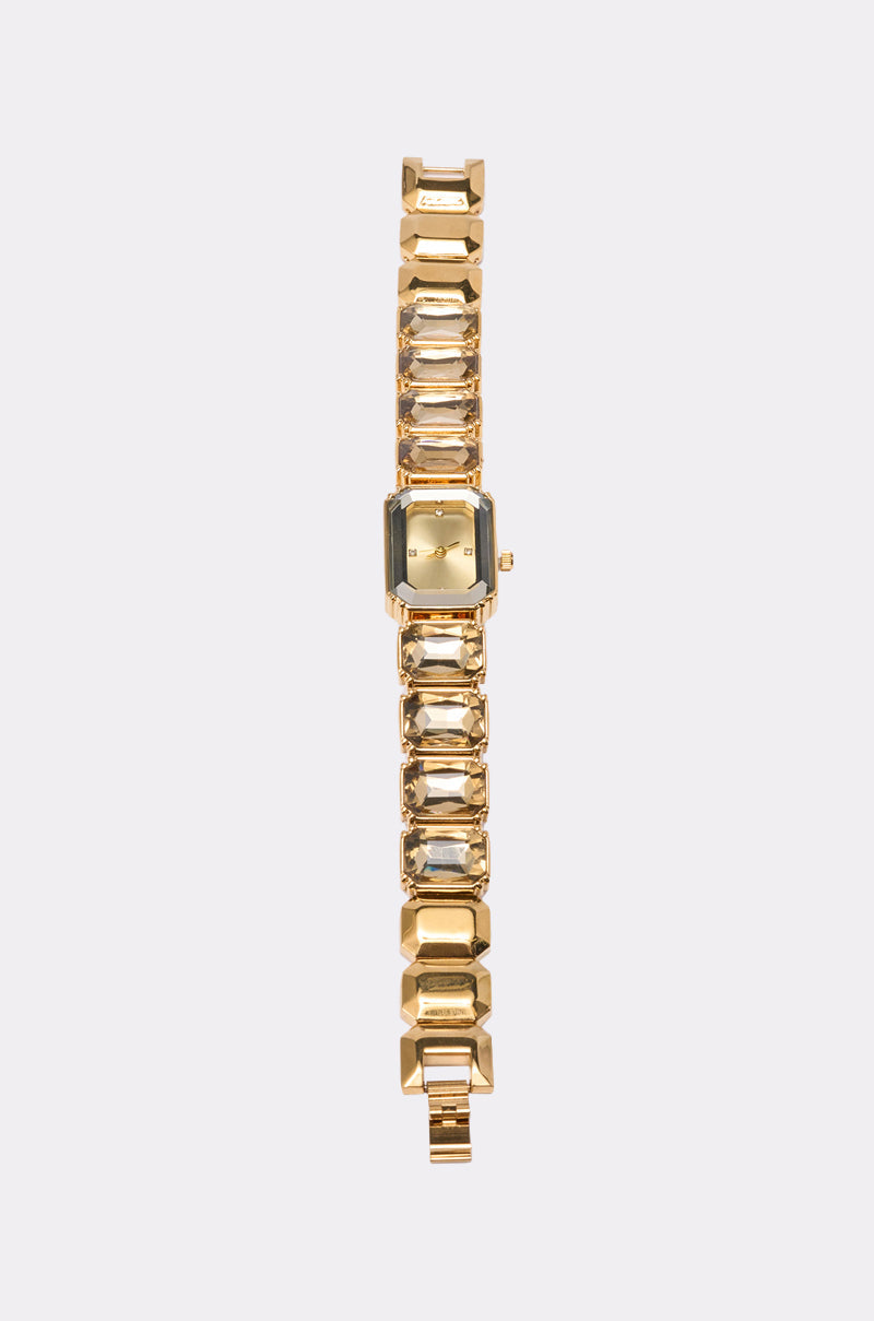 The SO GROOVY WATCH IN YELLOW features a gold-tone rectangular face and a chunky geometric link bracelet, displayed vertically on a plain light background. 2