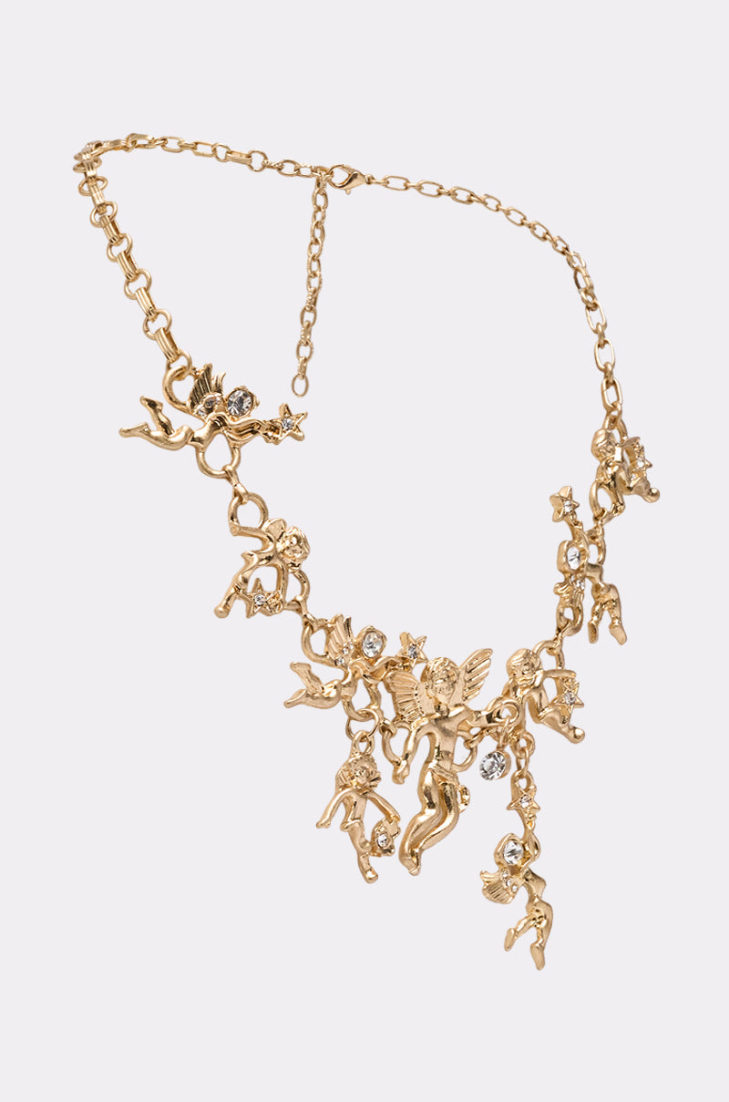 The ANGELIC NECKLACE is a vintage-inspired gold piece with multiple angel and cherub charms accented by clear gemstones, shown on a plain white background. 2