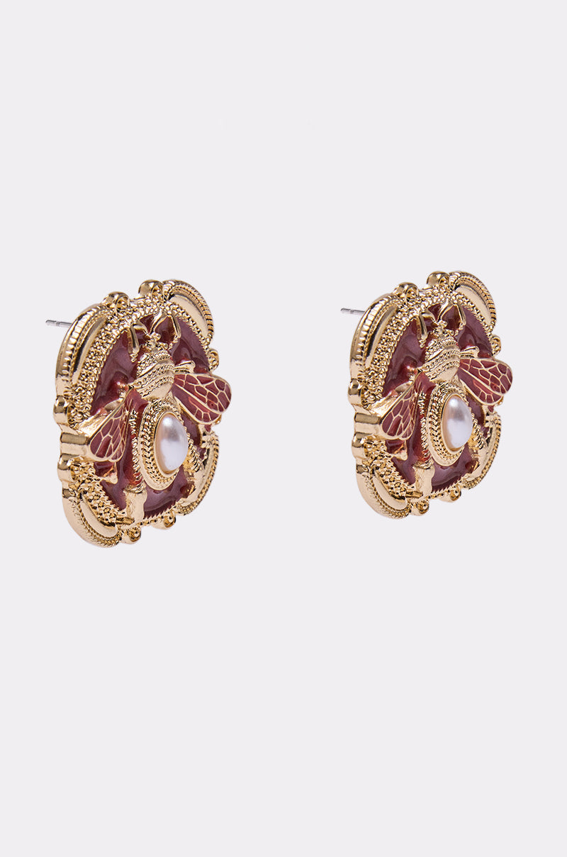 DESI EARRING: Ornate gold metallic earrings with detailed bee design, maroon accents, and faux pearl embellishments, shown on a plain white background. 2