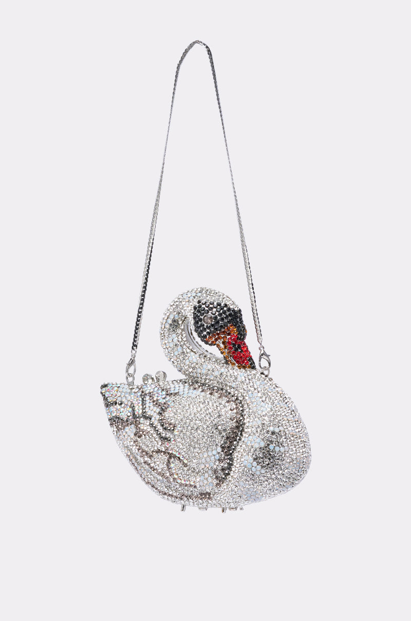 The REGAL BLING CLUTCH, a swan-shaped evening bag adorned with silver, black, and red rhinestones and a metallic shoulder strap, dazzles beautifully against a plain light background. 2
