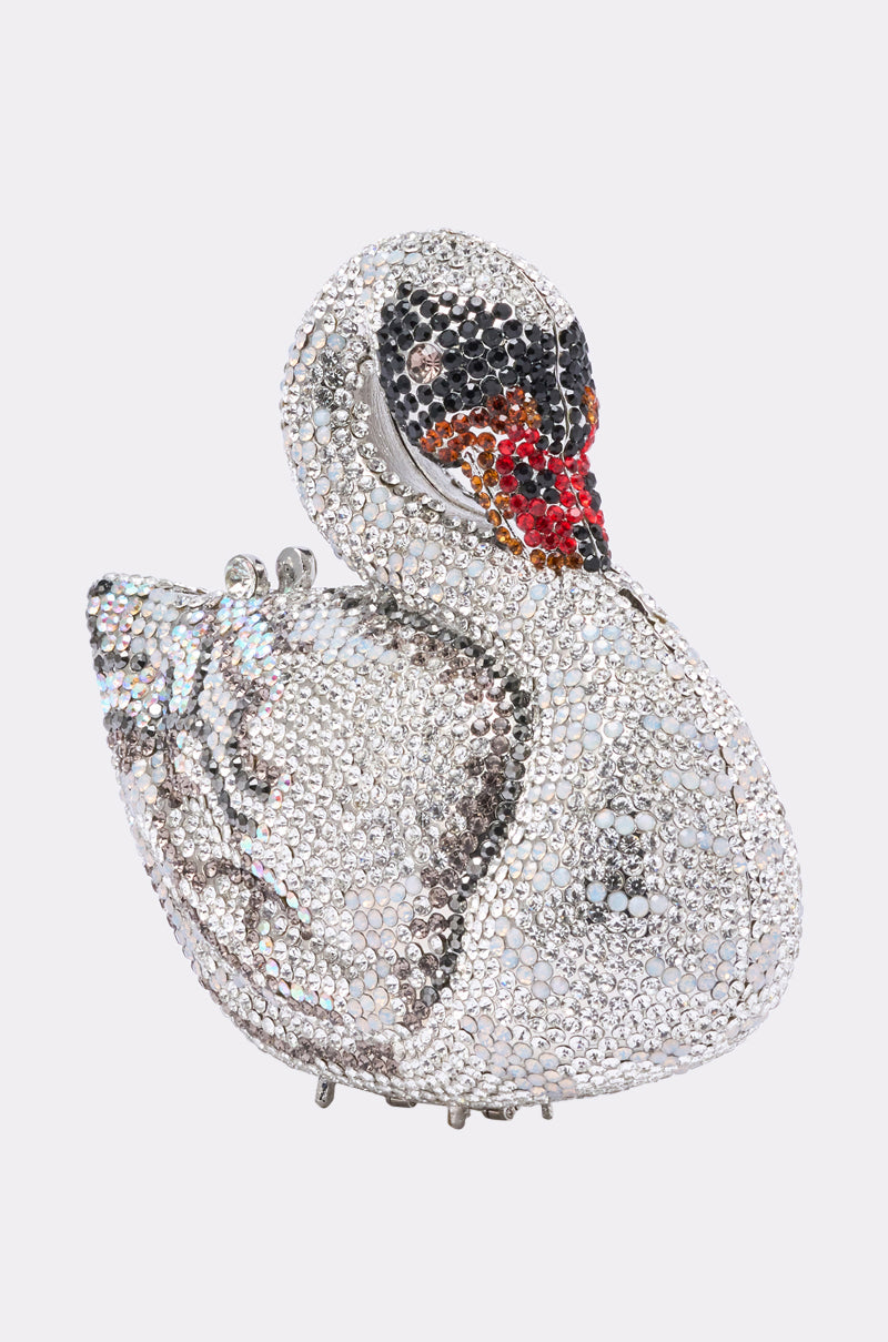 The REGAL BLING CLUTCH is a metallic evening bag shaped like a swan, adorned with silver, black, and red rhinestones that form an intricate, sparkling bird design against a light background. 3