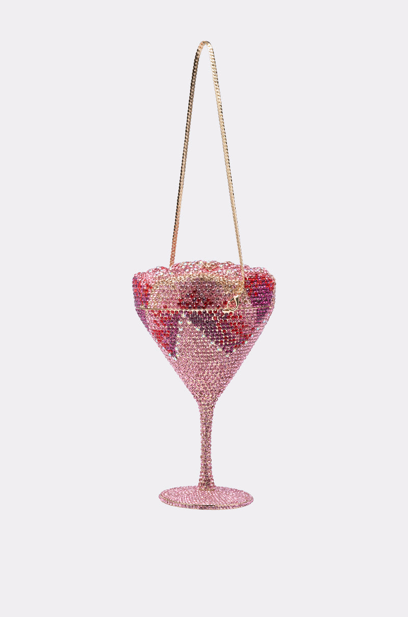 The TAKE A SIP BLING PURSE is a martini glass clutch adorned with pink and red rhinestones and a gold chain strap, making it the ultimate statement accessory against any plain light background. 7
