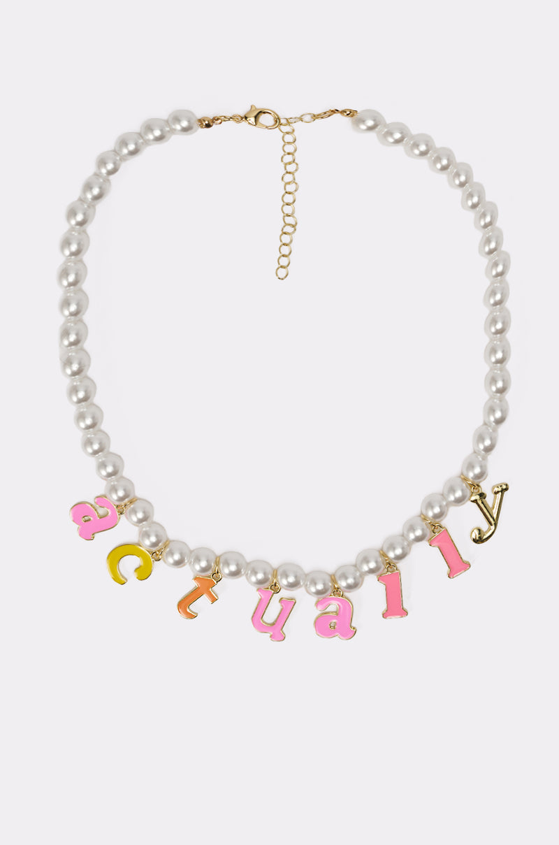 The I SAID WHAT I SAID NECKLACE features faux pearls, a gold clasp, an adjustable extender chain, and pink and yellow enamel letter charms that spell out "I SAID WHAT I SAID. 3