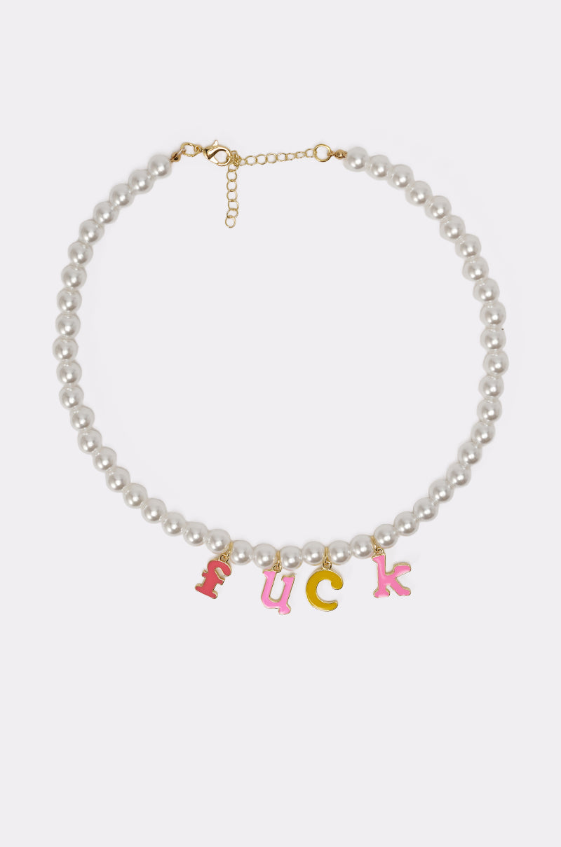 The I SAID WHAT I SAID NECKLACE features faux pearls, a gold clasp, and pink/yellow enamel letter charms spelling out a bold phrase. Includes an adjustable extender chain for a perfect fit. 4