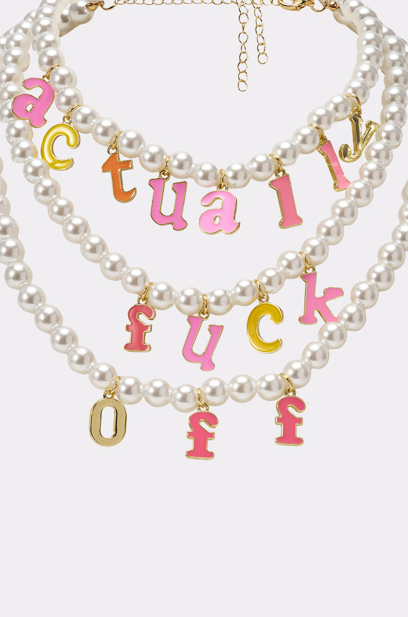 The I SAID WHAT I SAID NECKLACE features three faux pearl statement necklaces with gold clasps and pink-and-gold enamel letter charms boldly spelling “actually,” “fuck,” and “off.”. 6