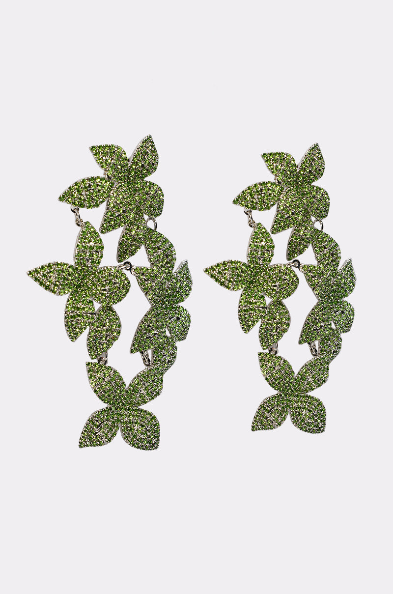 The IN MY GARDEN EARRING features floral rhinestone clusters of green, glittering leaves in a circular wreath design, shown on a plain white background. 4