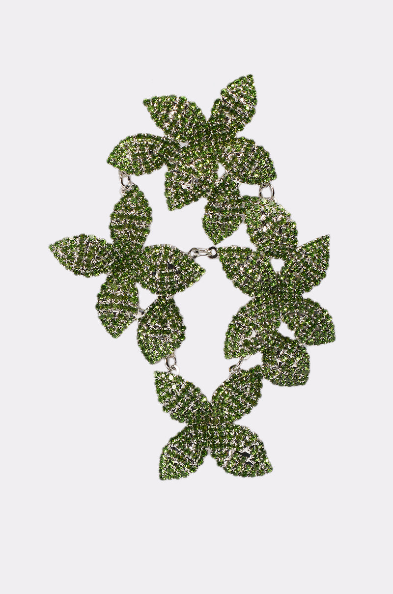The IN MY GARDEN EARRING showcases bold green leaf clusters encrusted with sparkling stones, arranged in a circular design—perfect for statement looks. Featured on a simple white background. 5