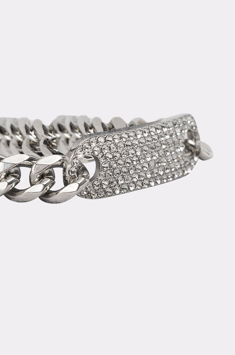 A close-up of the LETS LINK BRACELET shows its silver curb links and a rectangular plate adorned with sparkling clear stones, set against a plain, light-colored background. 4