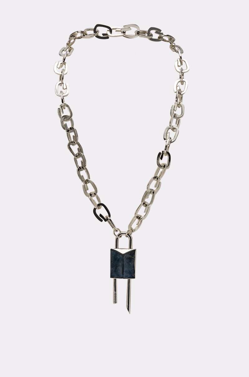 The LOCK IT UP NECKLACE is a silver-tone chunky chain with oversized, uneven links, featuring a bold lock pendant and two vertical metal bars, all displayed on a plain white background. 1