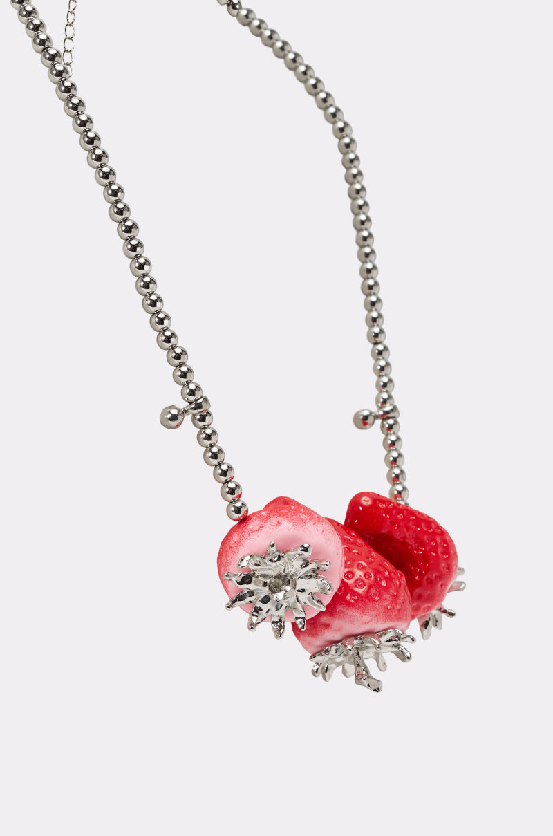 The BITE ME STRAWBERRY NECKLACE is a silver ball chain with three realistic bitten strawberry charms and detailed silver leaves, shown on a plain white background. 4