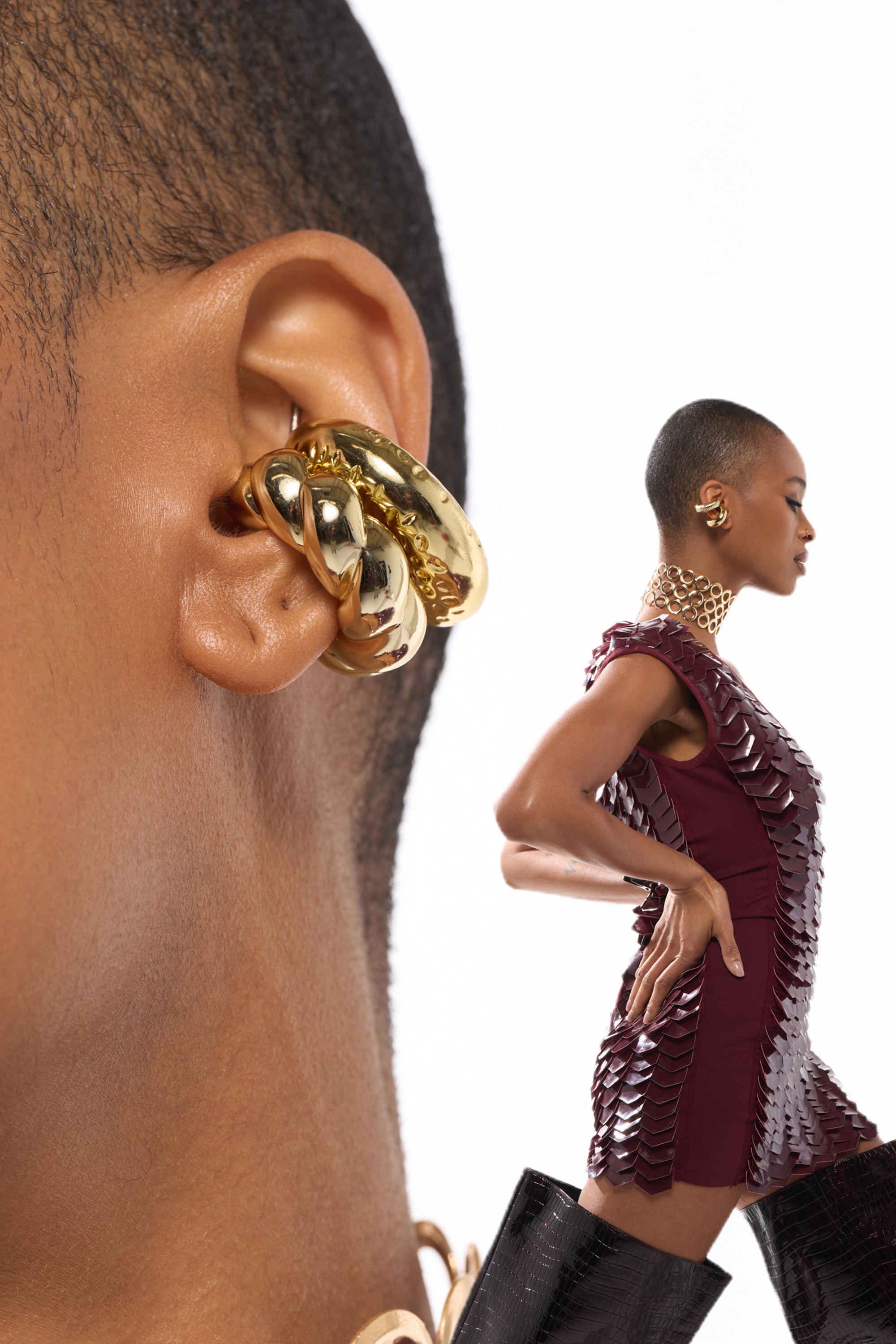 A close-up shows a person wearing chunky gold earrings from the ULTIMATE EAR CUFF SET—ideal no-piercing jewelry. In front, they pose in a textured burgundy dress, gold necklace, and black boots, set against a white background. 0