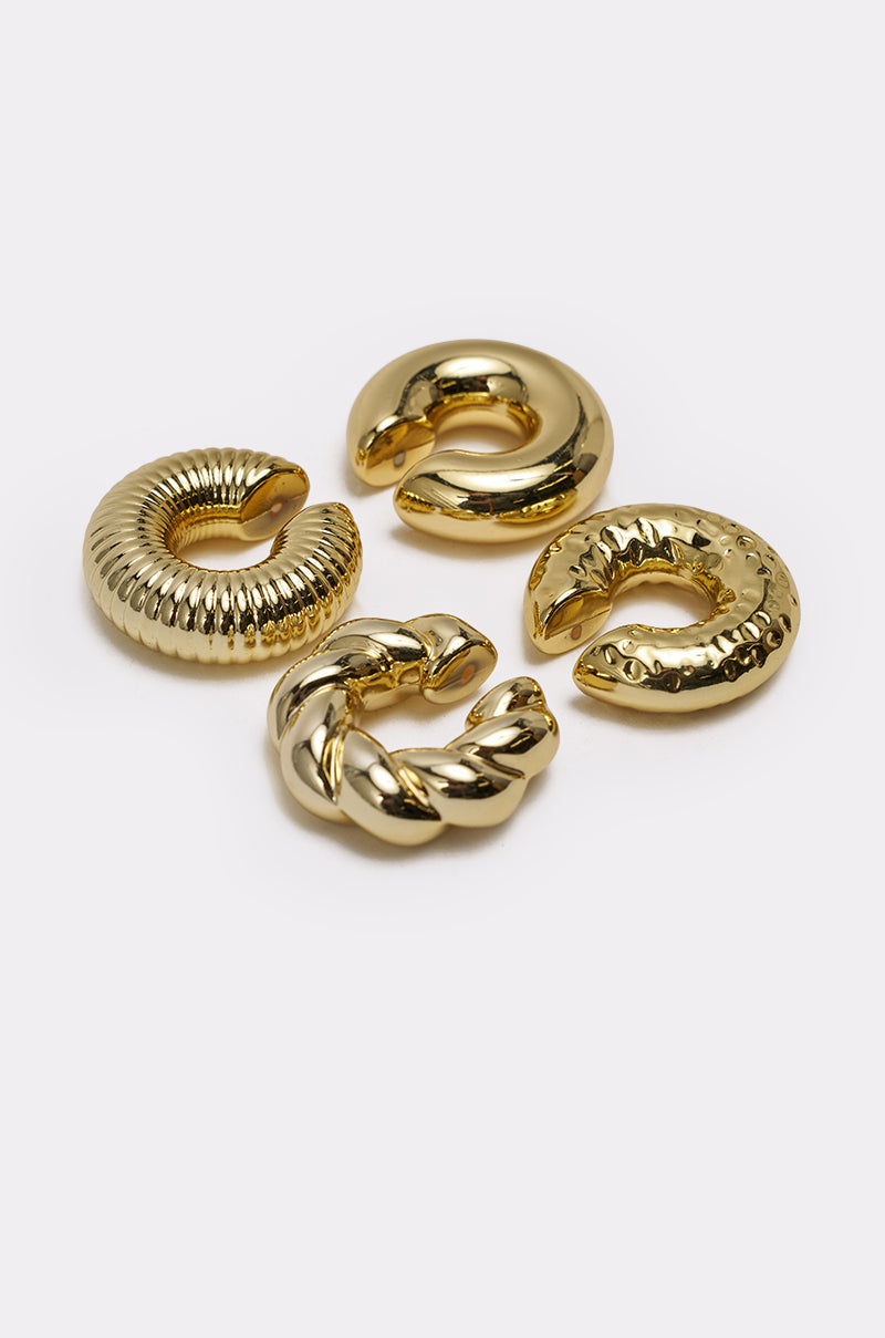 The ULTIMATE EAR CUFF SET offers a collection of gold ear cuffs for a stylish stacked-ear look—no piercings required. 2
