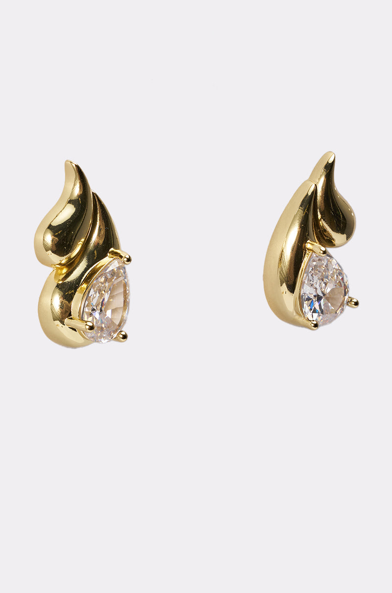 The OLD MONEY EARRING is a pair of gold teardrop earrings with a flame-inspired design and pear-shaped clear gemstones, set against a plain white background—elegant and ideal for special occasions. 3