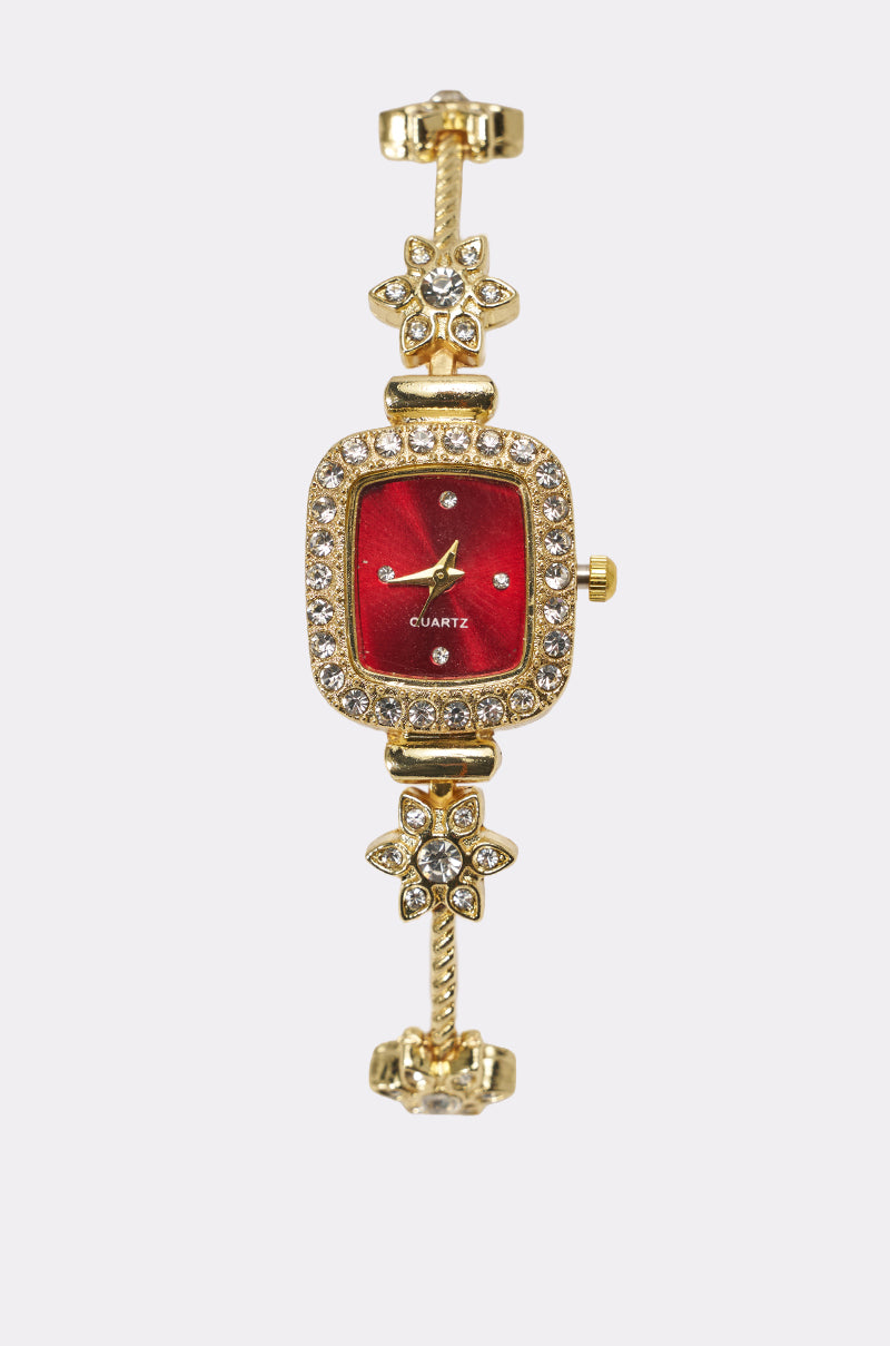 The ELEGANCE WATCH features a vintage-inspired gold-tone square case with a red face, sparkling rhinestone accents, and a floral band adorned with clear gemstones for an elegant, decorative style. 2