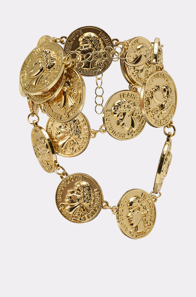 The IN MY BAG BRACELET is a vintage-glam accessory with embossed classical coin-like charms and decorative text, all linked together in an elegant, ornate design. 2