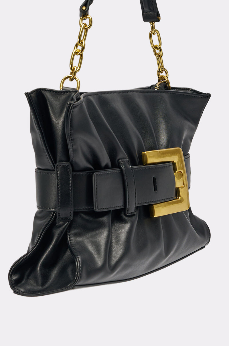 The OVERSEAS BUCKLE CLUTCH is a black faux leather handbag with a gold chain strap, prominent buckle detail, and a gathered, ruched texture—an elegant statement piece for any occasion. 3