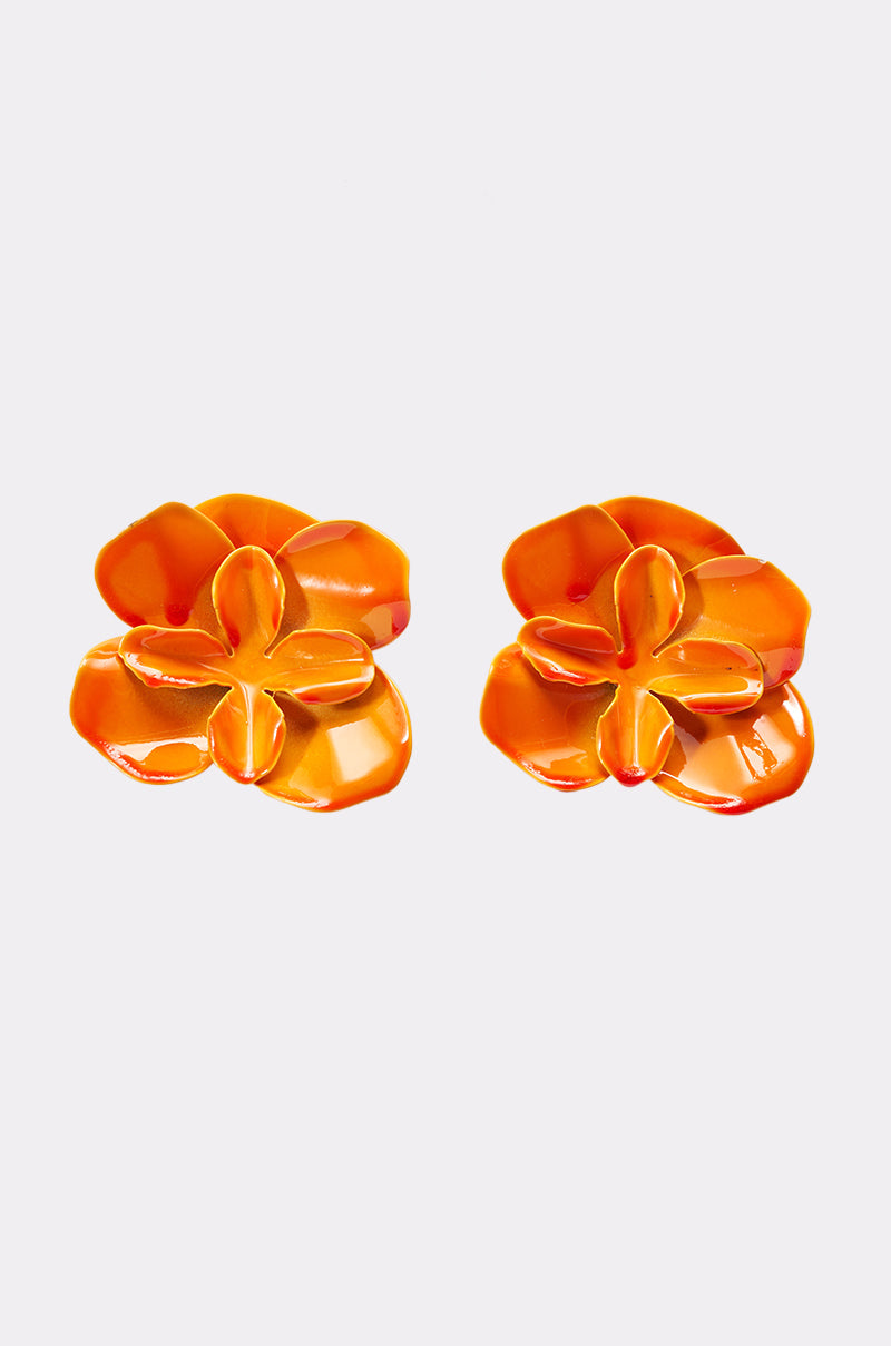 The ON DND EARRING showcases two glossy, orange enamel floral studs with smooth, rounded petals on a plain white background—perfect statement flower earrings for summer. 1