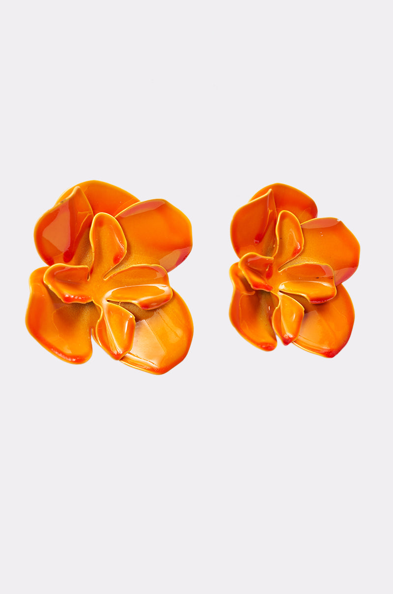 The ON DND EARRING features two orange floral studs with glossy, petal-like enamel details, displayed on a clean white background—ideal for adding a bright touch to your summer statement style. 4